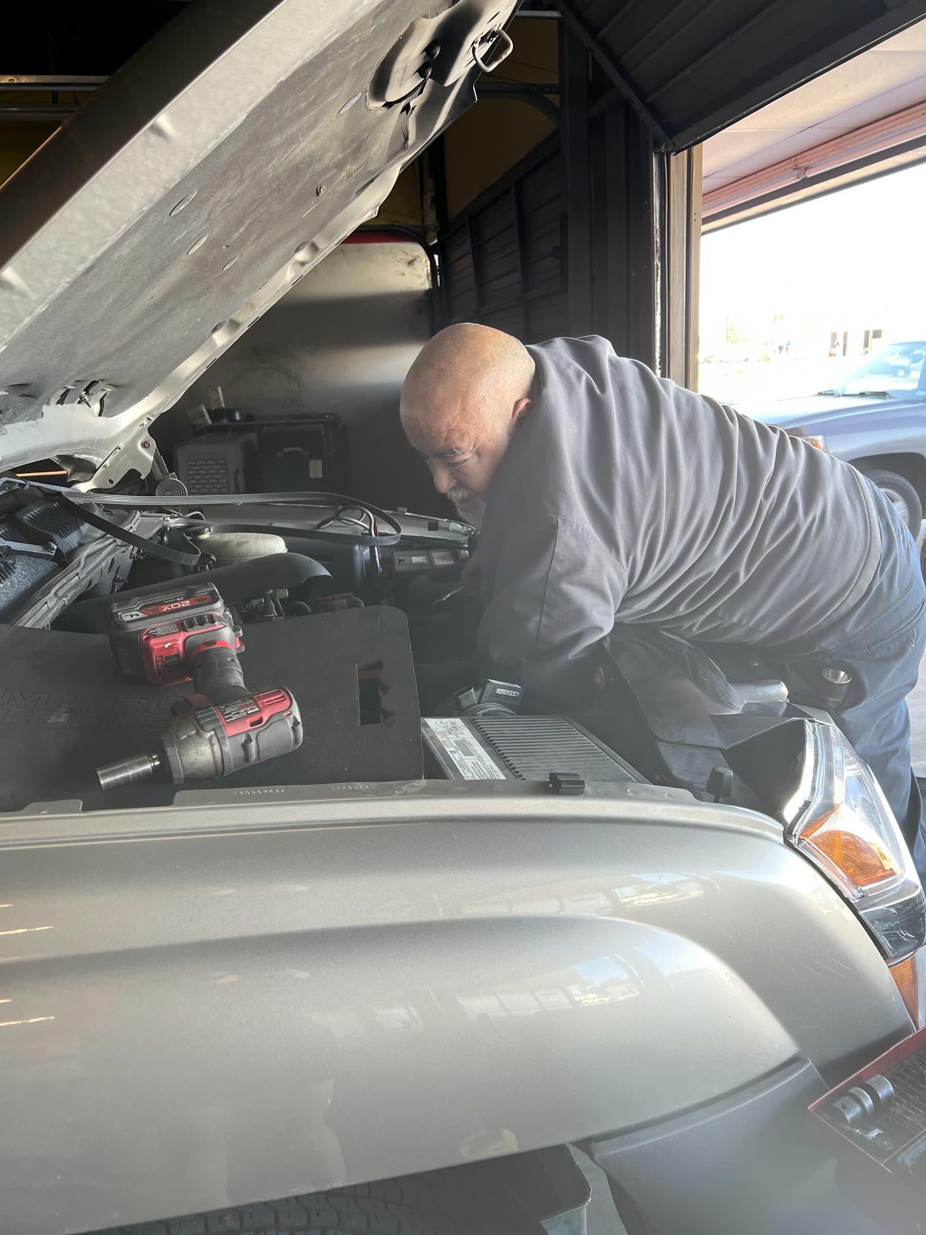Mechanic servicing a vehicle engine